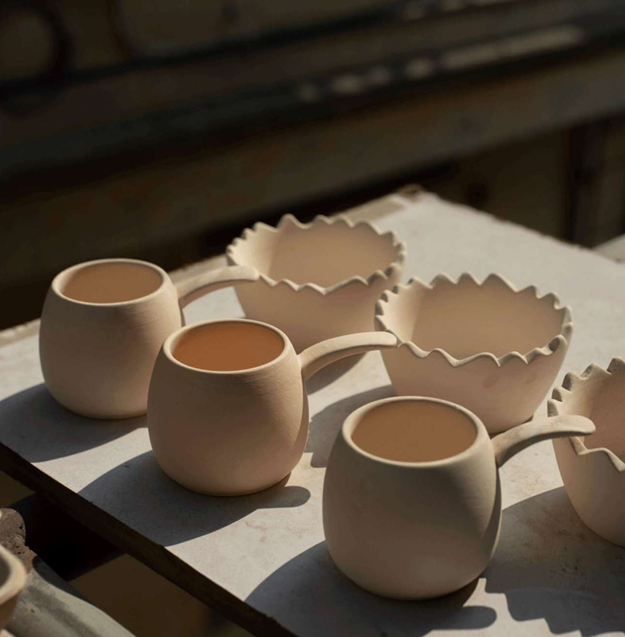 Unglazed handmade egg cups drying in the sun at Bat Trang