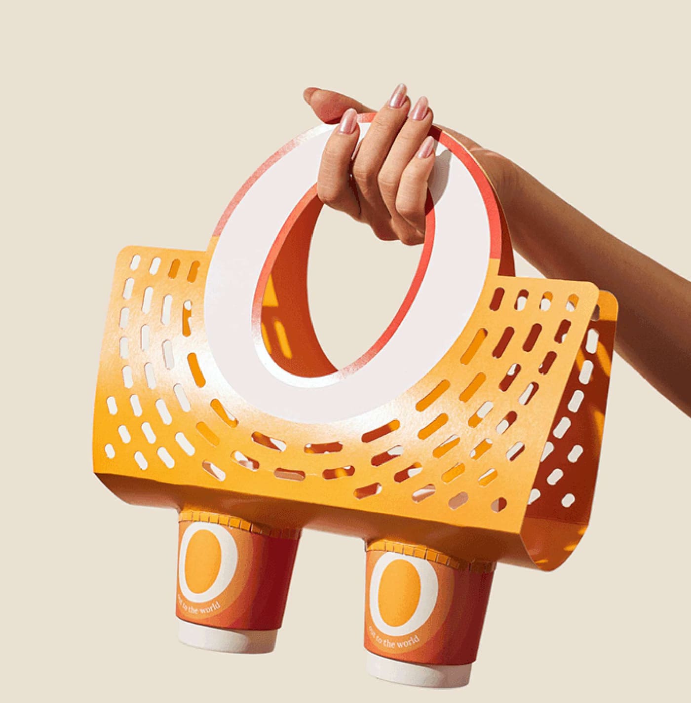 Stacked takeaway cups and a cup carrier in Eggyolk's sunrise colours